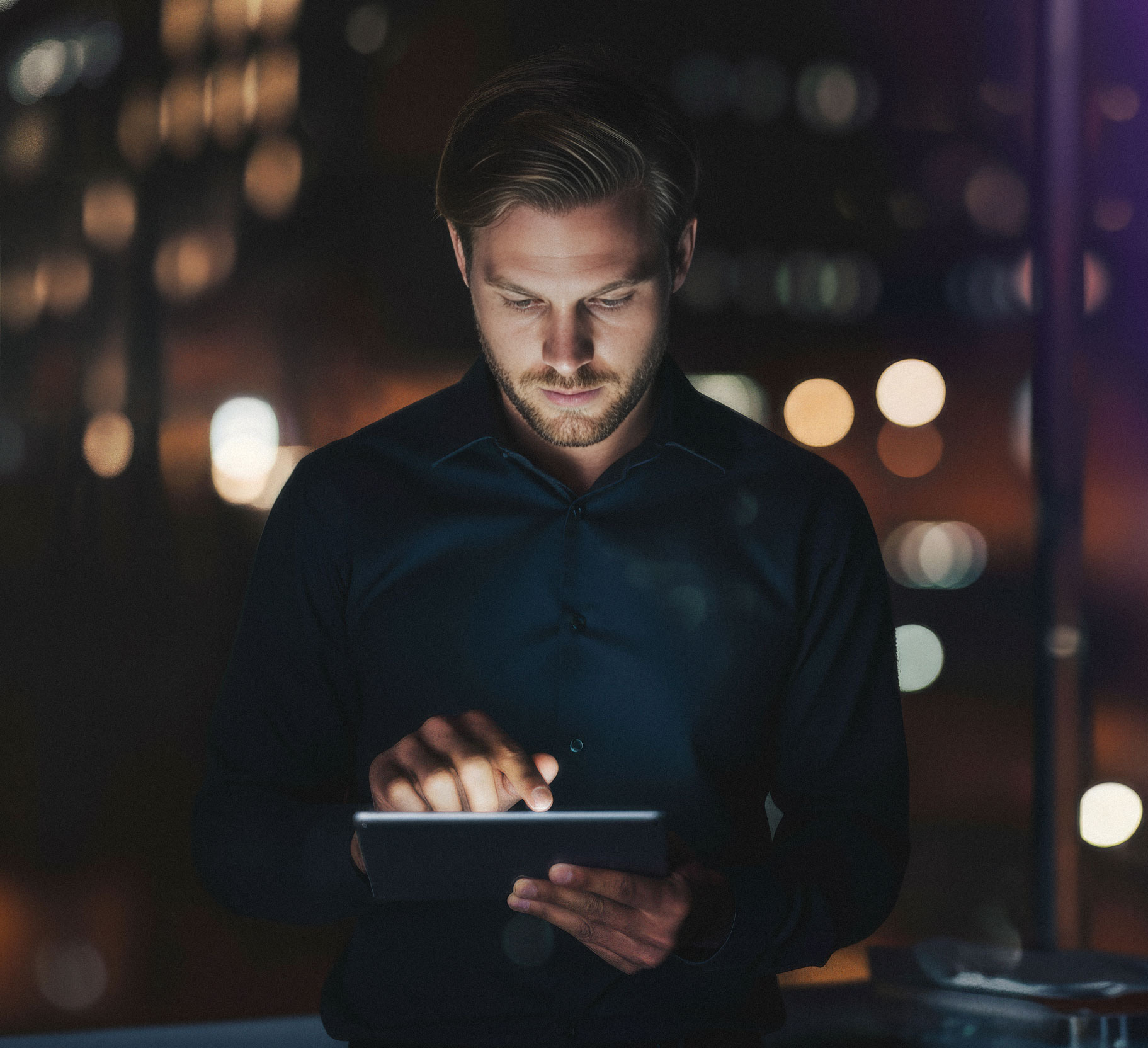 Man-working-with-surfpad-at-night