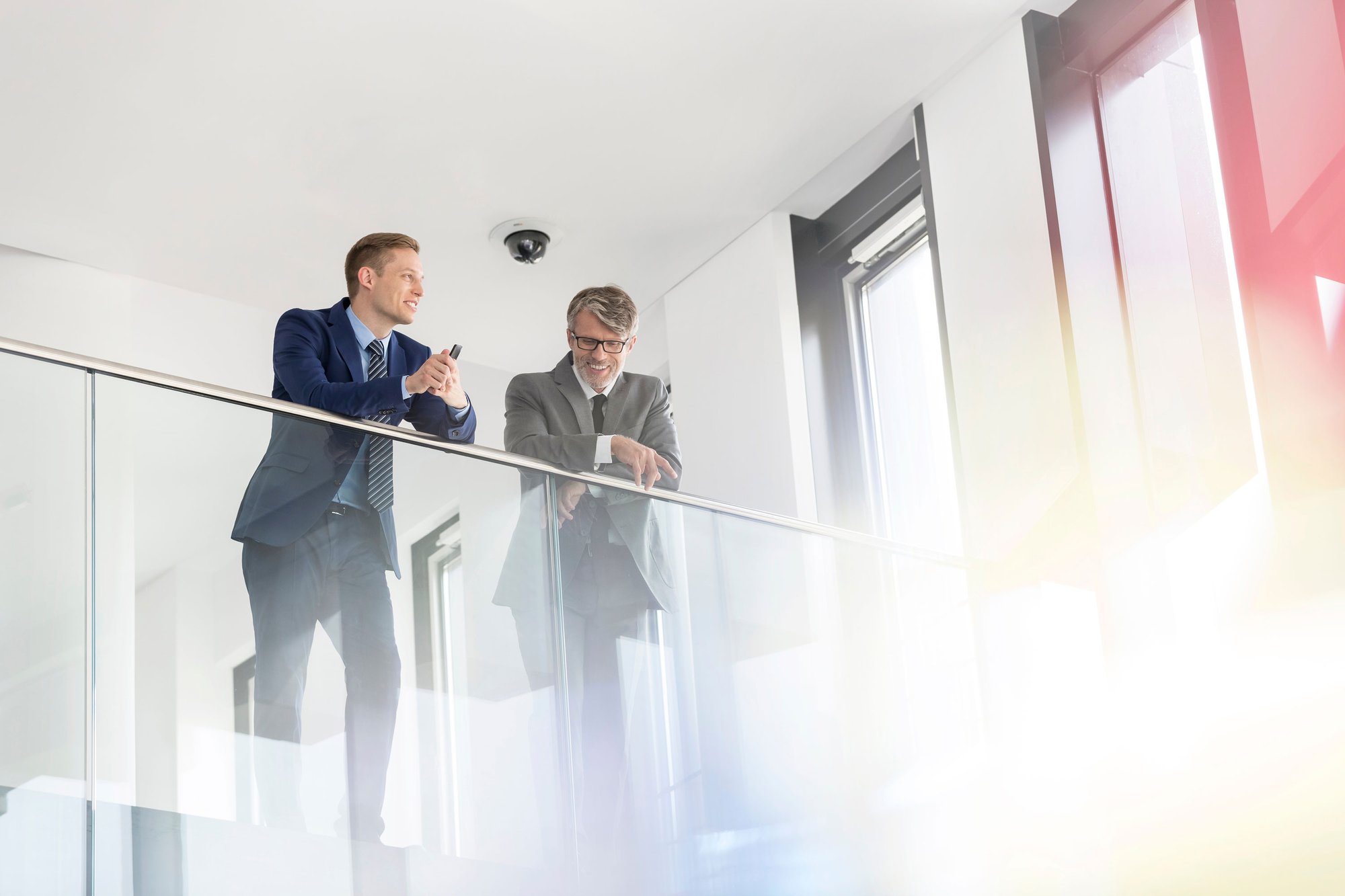 two-men-standing-behind-glass