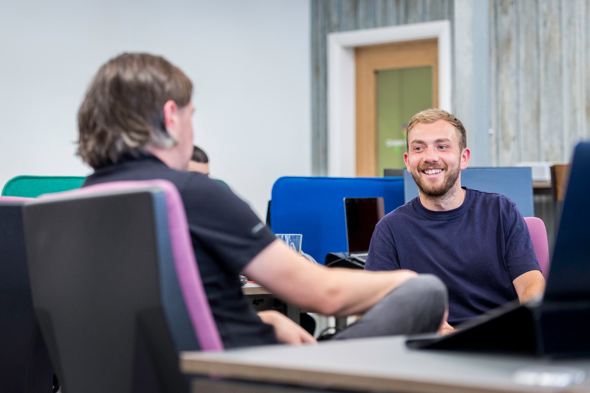 Two men chatting in UK office Chris Knowles and Will troup Avidly