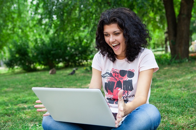 Woman happy using laptop