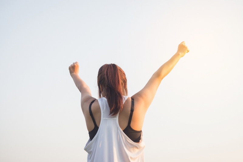 Canva - Happy Successful Sportswoman Raising Arms to the Sky on Golden B